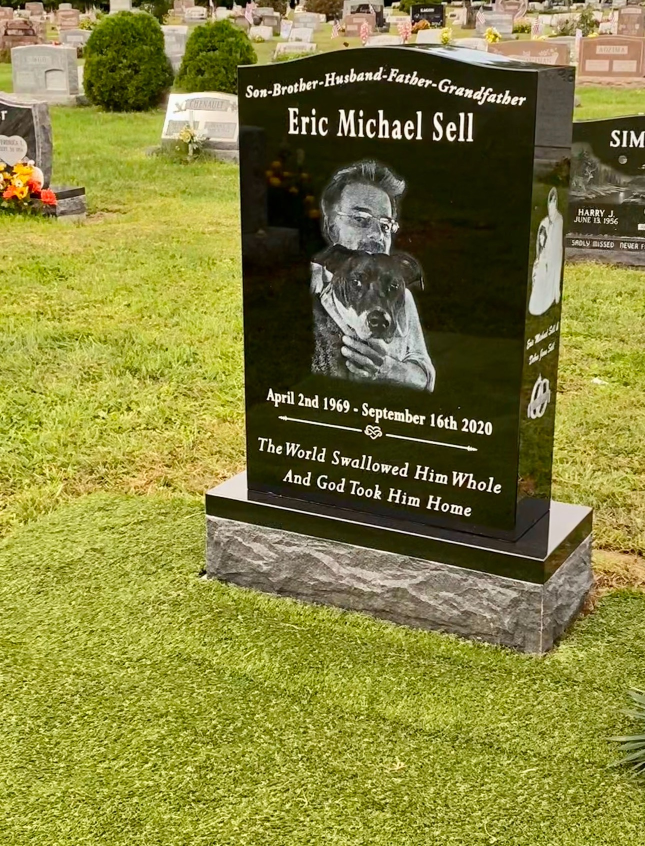 Black granite monument with engraved portrait and dog