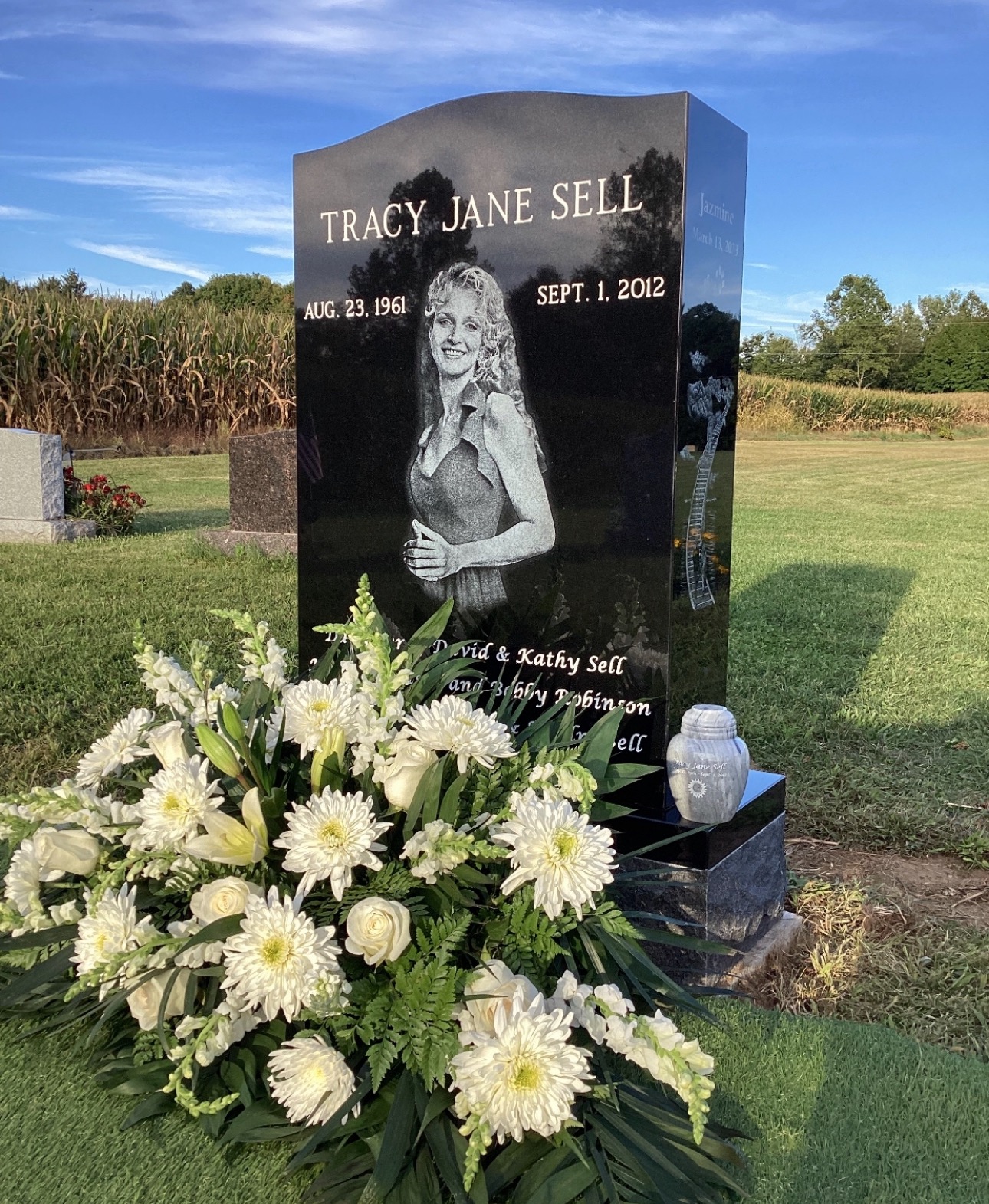 Black granite upright monument with engraved portrait